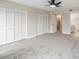 Spacious bedroom with grey carpet, double closets, and access to bathroom at 291 Winchester Way, Palm Harbor, FL 34684