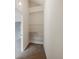 Well-lit closet with wire shelving for convenient storage at 291 Winchester Way, Palm Harbor, FL 34684