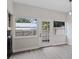 Dining room with hardwood floors and sliding glass doors leading to a patio at 291 Winchester Way, Palm Harbor, FL 34684