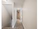 Upstairs hallway with neutral-colored carpet and access to bedrooms at 291 Winchester Way, Palm Harbor, FL 34684