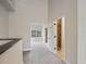 Bright hallway with carpet flooring, leading to bedrooms and a bathroom at 291 Winchester Way, Palm Harbor, FL 34684