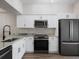 Modern kitchen with stainless steel appliances and pantry at 291 Winchester Way, Palm Harbor, FL 34684
