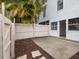 Small, fenced patio with concrete slab and access from sliding glass doors at 291 Winchester Way, Palm Harbor, FL 34684