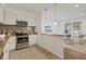 Open concept kitchen features stainless steel appliances and flows into the living room at 2912 N 16Th St # 1/2, Tampa, FL 33605