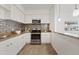 Modern kitchen with stainless steel appliances and stylish backsplash at 2912 N 16Th St # 1/2, Tampa, FL 33605