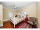 Bright bedroom with a floral bedspread and hardwood floors at 308 Druid W Rd, Clearwater, FL 33756