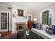 Elegant living room featuring a fireplace, stained-glass window, and comfortable seating at 308 Druid W Rd, Clearwater, FL 33756