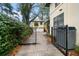 Backyard access with a gate, concrete pathway, and detached garage at 308 Druid W Rd, Clearwater, FL 33756