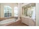 Bathroom with a large soaking tub and vanity at 34303 Sahalee Loop, Dade City, FL 33525