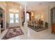 Spacious entryway with double doors, chandelier, and dining room view at 34303 Sahalee Loop, Dade City, FL 33525