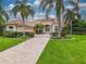One story house with tile roof and palm trees at 34303 Sahalee Loop, Dade City, FL 33525