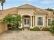 House exterior view with double doors, columns, and landscaping at 34303 Sahalee Loop, Dade City, FL 33525