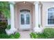 Inviting front entrance with double doors, columns, and landscaping at 34303 Sahalee Loop, Dade City, FL 33525