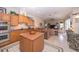 Open concept kitchen with island and view into Gathering room at 34303 Sahalee Loop, Dade City, FL 33525