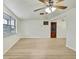 Living room with wood-look floors and brick accent wall at 3523 Blayton St, New Port Richey, FL 34652