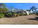 Screened patio with lush landscaping and mature trees at 377 Jenico Ct, Spring Hill, FL 34609