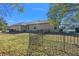 Landscaped backyard with a fenced perimeter, showcasing the home's exterior at 377 Jenico Ct, Spring Hill, FL 34609