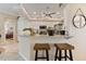 Kitchen boasts a breakfast bar with granite countertops and wooden stools at 377 Jenico Ct, Spring Hill, FL 34609