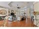 Open living room with hardwood floors, ample seating, and a view to the kitchen and dining area at 377 Jenico Ct, Spring Hill, FL 34609