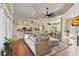 Bright living room with hardwood floors, a large sectional sofa, and views to the kitchen at 377 Jenico Ct, Spring Hill, FL 34609