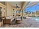 Relaxing poolside patio with wicker furniture and a view of the pool at 377 Jenico Ct, Spring Hill, FL 34609