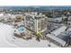 Aerial view of beachfront high-rise building with pool and parking at 3820 Gulf Blvd # 203, St Pete Beach, FL 33706