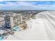 Aerial view of beachfront high-rise building, beach, and ocean at 3820 Gulf Blvd # 203, St Pete Beach, FL 33706