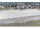 Aerial view of beachfront high-rise building and white sand beach at 3820 Gulf Blvd # 203, St Pete Beach, FL 33706
