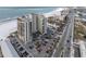 Aerial view of beachfront building with parking and ocean at 3820 Gulf Blvd # 203, St Pete Beach, FL 33706