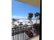 Balcony view of beach, parking lot, and ocean at 3820 Gulf Blvd # 203, St Pete Beach, FL 33706