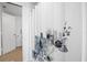 Bathroom with shower and floral shower curtain at 3820 Gulf Blvd # 203, St Pete Beach, FL 33706