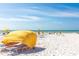 Beach access with yellow shade canopies and lounge chairs at 3820 Gulf Blvd # 203, St Pete Beach, FL 33706