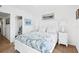 Guest bedroom with white furniture and ocean-themed bedding at 3820 Gulf Blvd # 203, St Pete Beach, FL 33706