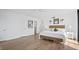 Bright bedroom with a comfortable bed and light wood floors at 3820 Gulf Blvd # 203, St Pete Beach, FL 33706