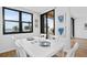 Bright dining room with ocean view and white table at 3820 Gulf Blvd # 203, St Pete Beach, FL 33706