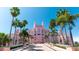 Pink hotel building with palm trees and a grand entrance at 3820 Gulf Blvd # 203, St Pete Beach, FL 33706