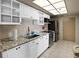 Modern kitchen with granite counters and stainless steel appliances at 3820 Gulf Blvd # 203, St Pete Beach, FL 33706