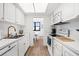 White kitchen with modern appliances and ocean view at 3820 Gulf Blvd # 203, St Pete Beach, FL 33706