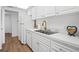 White kitchen with stainless steel appliances and gold fixtures at 3820 Gulf Blvd # 203, St Pete Beach, FL 33706