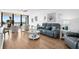 Bright living room with ocean view, comfy seating, and hardwood floors at 3820 Gulf Blvd # 203, St Pete Beach, FL 33706