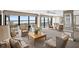 Spacious living room with ocean views and comfortable seating at 3820 Gulf Blvd # 203, St Pete Beach, FL 33706