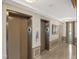 Building Lobby with two elevators and modern decor at 3820 Gulf Blvd # 203, St Pete Beach, FL 33706