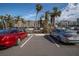 Parking lot with two cars in front of beachfront building at 3820 Gulf Blvd # 203, St Pete Beach, FL 33706