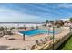 Inviting pool area with ocean views and lounge chairs at 3820 Gulf Blvd # 203, St Pete Beach, FL 33706