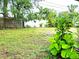 Backyard with grassy area, tropical plants, and wooden fence at 3843 19Th N Ave, St Petersburg, FL 33713