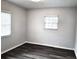 Simple bedroom with dark gray vinyl flooring and neutral walls at 3843 19Th N Ave, St Petersburg, FL 33713