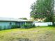 Back exterior view showing a sunroom and large yard at 3843 19Th N Ave, St Petersburg, FL 33713