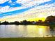 Scenic sunset over a tranquil lake with lush green grass and trees at 3843 19Th N Ave, St Petersburg, FL 33713