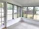Bright sunroom with glass windows and a door leading to the backyard at 3843 19Th N Ave, St Petersburg, FL 33713