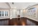 Living room with fireplace, built-in shelving, and dark hardwood floors at 3850 Olde Lanark Dr, Land O Lakes, FL 34638